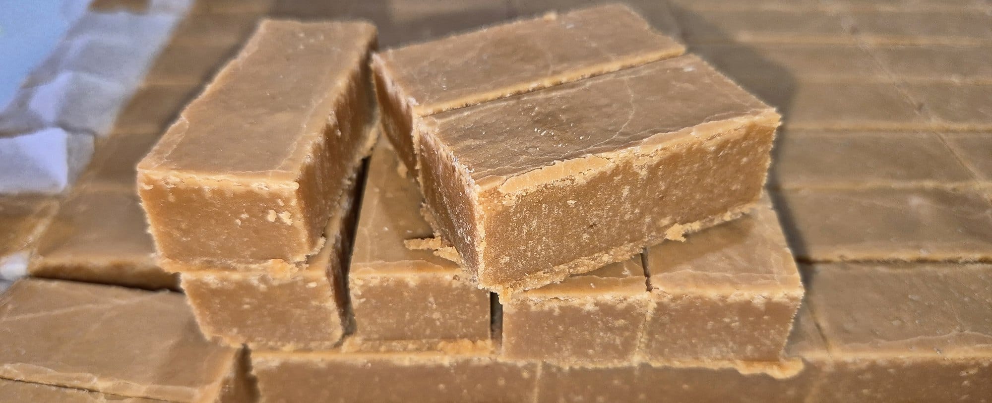 Barfi cut into bars, showing clean, straight sides